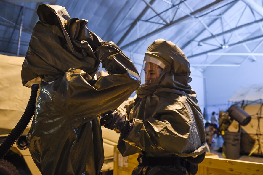 Capt. Jeffrey Yee and Capt. Matthew Burns, 628th Aerospace Medicine Squadron dental providers don chemical, biological, radiological and nuclear (CBRN) gear during a patient decontamination exercise drill here Sept. 15, 2016. 628th MDG conducted a joint certification course with Decon L.L.C., including an intensive, three day patient decontamination exercise to prepare Air Force medical responders to save lives, provide shelter and protect facilities in times of crisis.