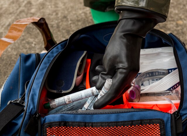 Capt. Jeffrey Yee, 628th Aerospace Medicine Squadron dental provider reaches for medical supplies during a patient decontamination exercise drill here Sept. 15, 2016. The exercise was conducted to train and prepare members of the 628th Medical Group and to maintain a first-response team ready to confront chemical related emergencies.