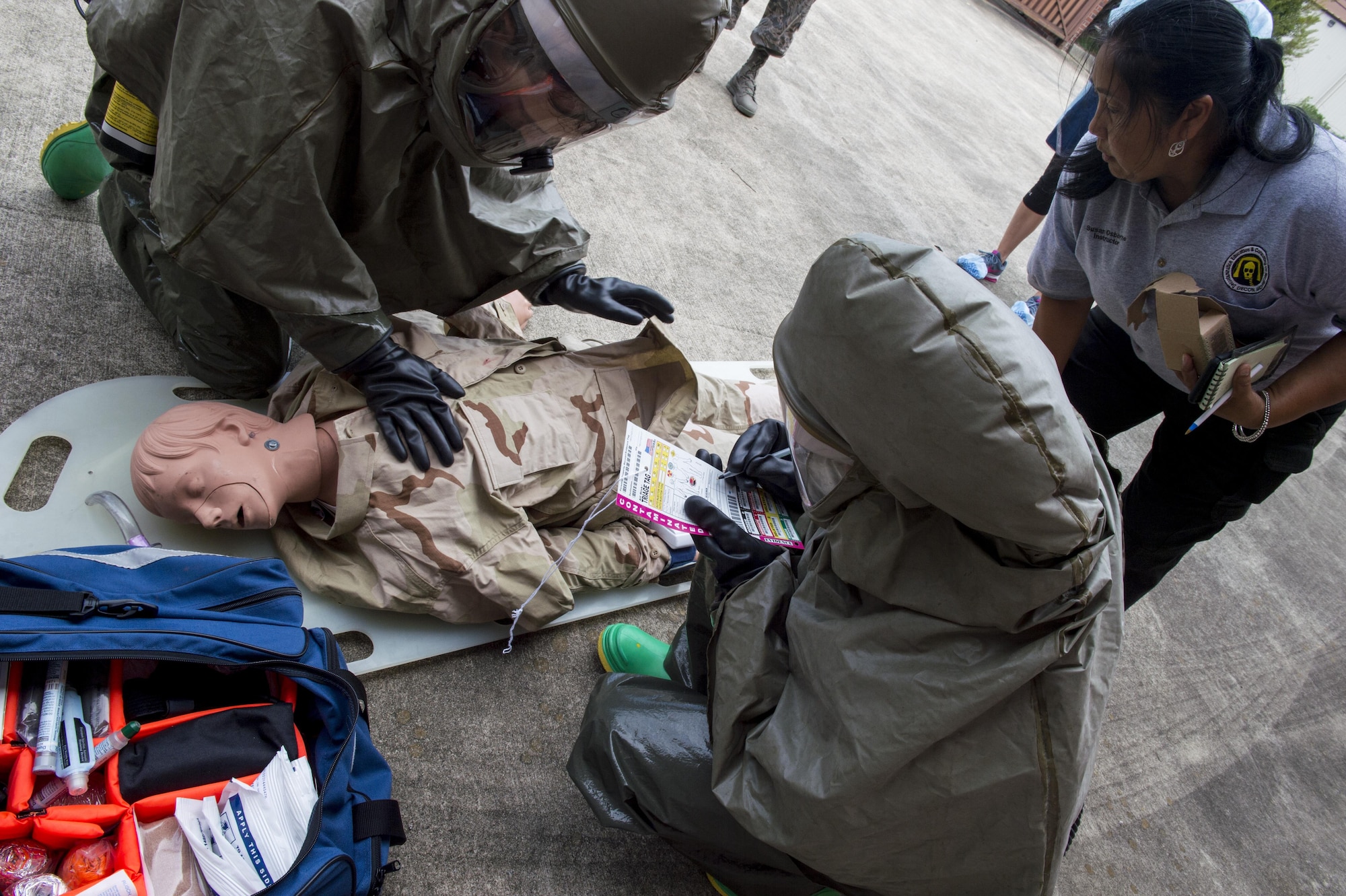 Susan Osborne, certified Decon L.L.C. instructor observes 628th Medical Group members during a patient decontamination drill here Sept. 15, 2016. The goal of the drill was to train participants in Hazardous Waste Operations. Once completed, the team is capable of recertifying other members of the In Place Patient Decontamination team.