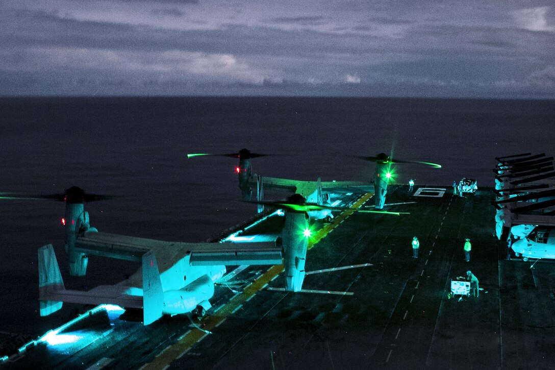 Two Marine Corps MV-22B Osprey tiltrotor aircraft idle aboard the flight deck of the USS Bonhomme Richard during low-light takeoff and landing exercises off the coast of the Northern Mariana Islands in the Philippine Sea, Sept. 18, 2016. Marine Corps photo by Staff Sgt. T.T. Parish