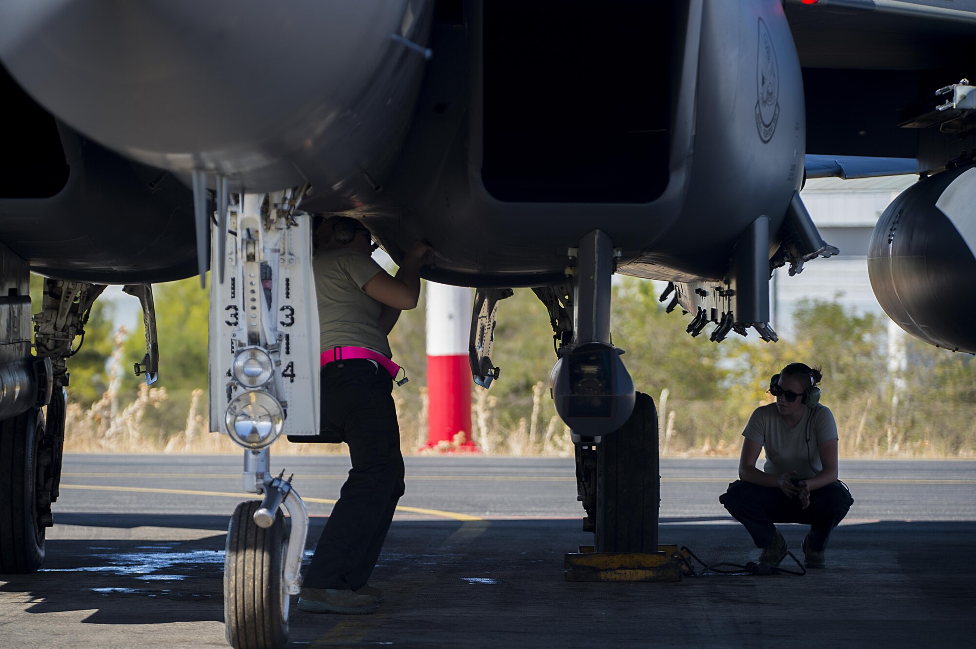 Airman 1st Class Savannah Chiles, 48th Aircraft Maintenance Squadron weapons load crew member (left) and Airman 1st Class Stephanie Niznik, 48th AMXS avionics systems journeyman, prepare an F-15E Strike Eagle for a sortie in support of Tactical Leadership Programme 16-3 at Los Llanos Air Base, Spain Sep. 19. Throughout its 39 year history, TLP has become the focal point for NATO’s Allied Air Forces tactical training, developing knowledge and leadership skills, necessary to face today's air tactical challenges. (U.S. Air Force photo/ Staff Sgt. Emerson Nuñez)