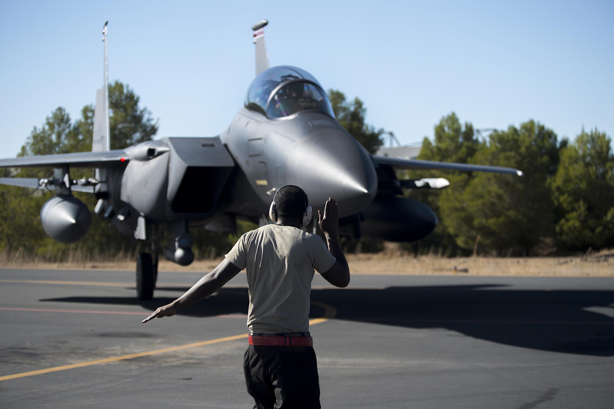 U.S. Air Force Staff Sgt. Branton Henderson, 48th Aircraft Maintenance Squadron dedicated crew chief, marshals in an F-15E Strike Eagle after a sortie in support of Tactical Leadership Programme 16-3 at Los Llanos Air Base, Spain Sep. 19. Training programs like the TLP showcase how the U.S. works side-by-side with NATO Allies and partners every day training to meet future security challenges as a unified force. (U.S. Air Force photo/ Staff Sgt. Emerson Nuñez)