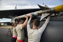 A three-man weapons load crew team from the 48th Aircraft Maintenance Squadron, load an AIM-120 missile onto the aircraft after a sortie in support of Tactical Leadership Programme 16-3 at Los Llanos Air Base, Spain Sep. 19. Throughout its 39 year history, TLP has become the focal point for NATO’s Allied Air Forces tactical training, developing knowledge and leadership skills, necessary to face today's air tactical challenges. (U.S. Air Force photo/ Staff Sgt. Emerson Nuñez)