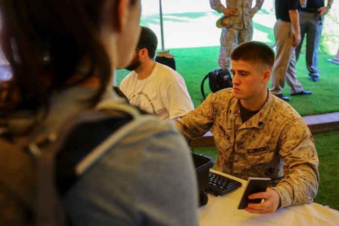 U.S. Marine Cpl. Kasey Ackley with the 22nd Marine Expeditionary Unit processes U.S. citizens  through the evacuation control center during a bilateral non-combatant evacuation exercise at the U.S. Embassy, Muscat, Oman, Sept. 21, 2016. The non-combatant evacuation exercise is an opportunity for the United States and Oman to practice a bilateral mission of quickly providing security and safety to U.S. and international citizens abroad during a natural disaster or contingency.