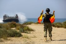 A U.S. Sailor with the 22nd Marine Expeditionary Unit guides a U.S. Navy Landing Craft Air Cushioned (LCAC) with Assault Craft Unit 4 during a bilateral non-combatant evacuation exercise at the U.S. Embassy, Muscat, Oman, Sept. 21, 2016. The non-combatant evacuation exercise is an opportunity for the United States and Oman to practice a bilateral mission of quickly providing security and safety to U.S. and international citizens abroad during a natural disaster or contingency.