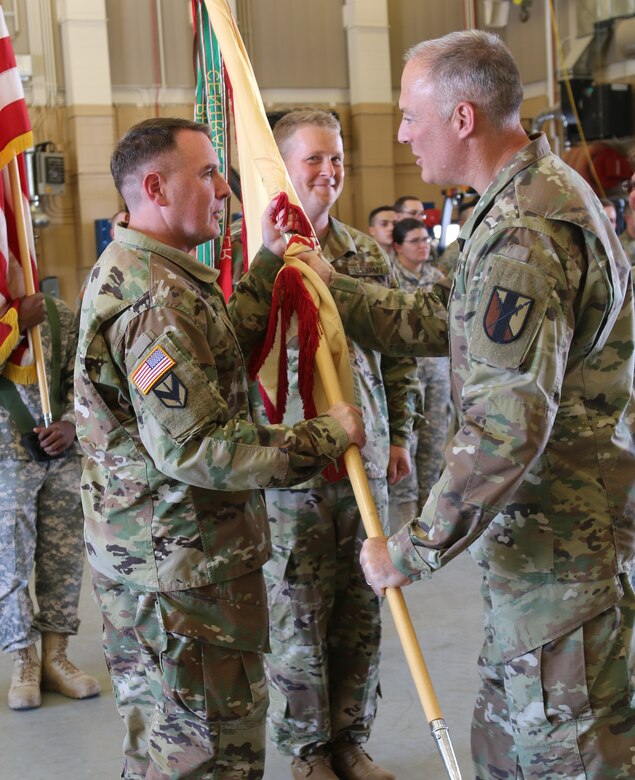 Lt. Col. Peter F. Gleason, a Tracy, California resident and 63rd Brigade Support Battalion incoming commander, is passed the unit guidon from Col. Joseph Riciardi, 303rd Maneuver Enhancement Brigade commander, and assumed command of the 63rd BSB from Lt. Col. Debra A. Cisney, who has led the unit for the past two years, at the George W. Dunaway Army Reserve Center in Sloan, Nev. September 10.