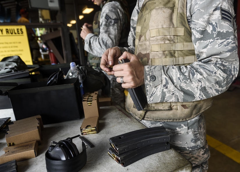 Senior Airman Natalie Plas, 1st Combat Camera Squadron combat broadcaster, loads ammunition prior to firing the M4 rifle here, Sept. 13, 2016. Airmen fired weapons as part of an M4 rifle qualification course in preparation for a deployment, permanent change of station move or as part of annual training. 