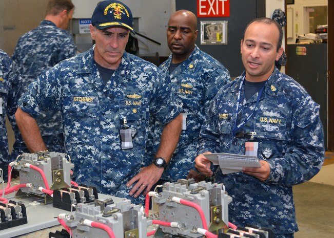 Chief Electrician's Mate Kevin Olivero explains how the Sailors at SERMC make cable repairs transformers at Southeast Regional Maintenance Center (SERMC) in Mayport Fla., to Rear Adm. Roy Kitchener, Commander, Expeditionary Strike Group 2 on Tuesday. The Shop at SERMC reconditions and balances alternating current motors for Mayport ships and those within SERMC's area of responsibility.