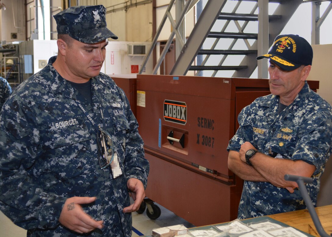 Fire Controllman 1st Class Geoffrey Bourget shows Rear Adm. Roy Kitchener, Commander, Expeditionary Strike Group 2, components of a Close-In Weapons System (CIWS). The CIWS/25mm Shop at Southeast Regional Maintenance Center inspect, troubleshoot, repair, overhaul, paint and test CIWS and 25mm Chain Guns for ships home ported in Mayport, Fla.