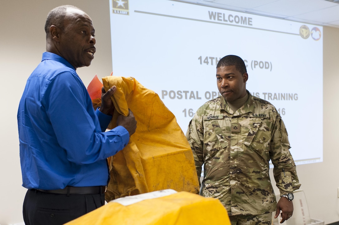 Anthony Perry, a Postal & Official Mail Management Analyst with the U.S. Army Reserve Command Services & Support Division, reviews mail-handling procedures during a Mission Readiness Exercise, Sept. 21, 2016 at Fort Bragg, N.C. Pfc. Jamaal Monroe, a mail specialist with the 14th Human Resources Sustainment Center, also at Fort Bragg, will be deploying to the U.S. Army Central Command theater. (U.S. Army photo by Timothy L. Hale)(Released)