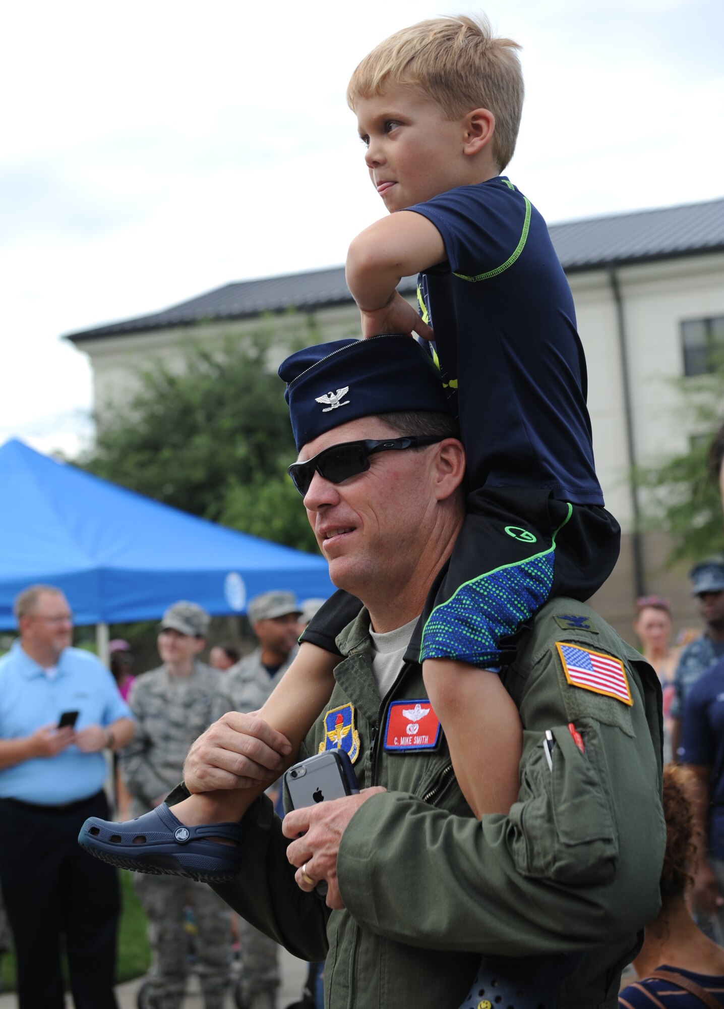 Col. C. Mike Smith, 81st Training Wing vice commander, and his son, Cam, watch the cake-cutting ceremony during Keesler’s Air Force birthday celebration in front of Vandenberg Hall Sept. 16, 2016, on Keesler Air Force Base, Miss. The event also included music and food to celebrate the Air Force’s 69th birthday. (U.S. Air Force photo by Kemberly Groue/Released)