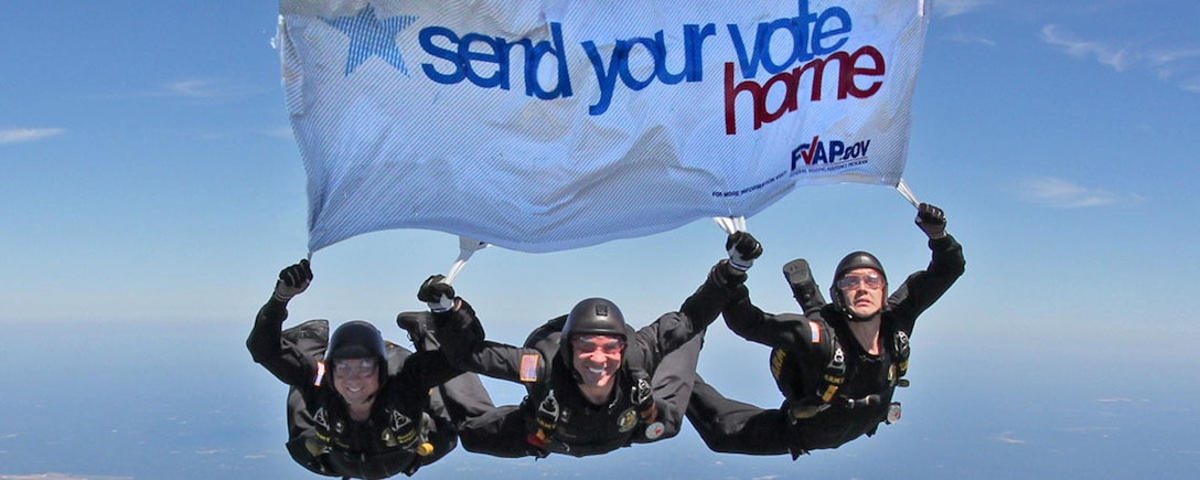 Members of the Army’s Golden Knights parachute team pass on the Federal Voting Assistance Program’s message for U.S. military and overseas citizens to submit their absentee ballots in time for the upcoming general election. DoD photo