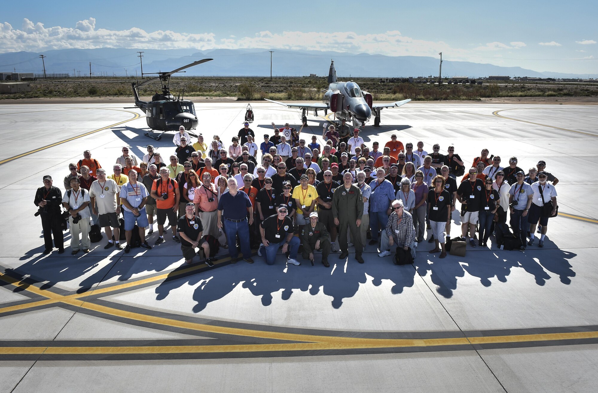 All 160 Phantom Society participants pose for a picture Sept. 13, 2016, at Holloman AFB. The Phantom II society is an international non-profit dedicated to the preservation of the history of the McDonnell Douglas F-4 Phantom II fighter. The tour enabled aircraft enthusiasts, including veterans and non-veterans with aviation backgrounds, to explore various base locations. The tour included an F-16 Fighting Falcon static and briefing, travel to Holloman’s High Speed Test Track, the opportunity to view QF-4s and F-16s in flight, and a visit to Heritage Park to view statics displays of various aircraft flown at Holloman AFB. (U.S. Air Force Photo by SSgt Stacy Jonsgaard)