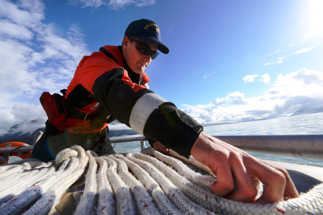 Coast Guard Fireman Apprentice Ryan Tyler mans the towline aboard the response boat-medium during towing drills in Valdez Harbor on Prince William Sound, Alaska, Sept. 13, 2016. Tyler is a fireman assigned to Coast Guard Station Valdez. The boats are conducting towing and man overboard drills for boat crew qualification. Coast Guard photo by Petty Officer 1st Class Bill Colclough