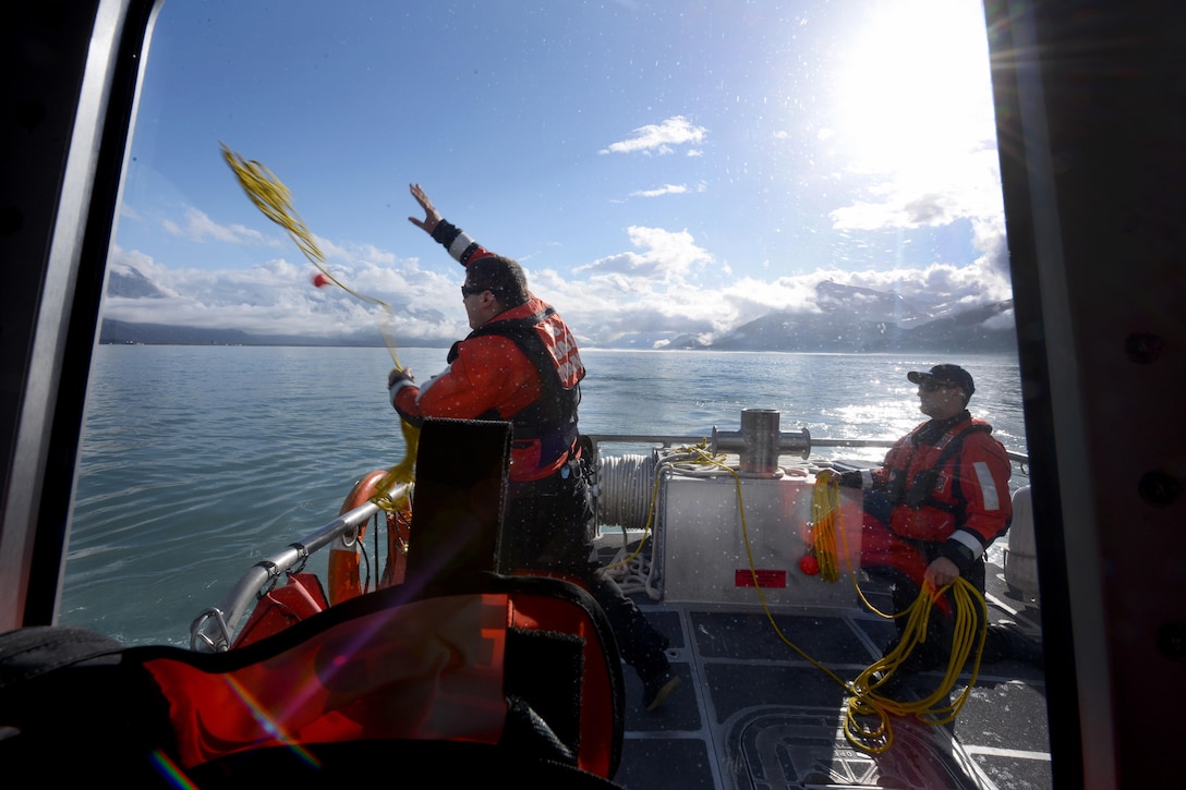 Coast Guard Petty Officer 3rd Class John Gerbrands, left, heaves a rescue line from aboard response boat-medium to the crew of a response boat-small during crewman qualification training in Valdez Harbor on Prince William Sound, Alaska, Sept. 13, 2016. Gerbands is assigned to Coast Guard Station Valdez. Coast Guard photo by Petty Officer 1st Class Bill Colclough