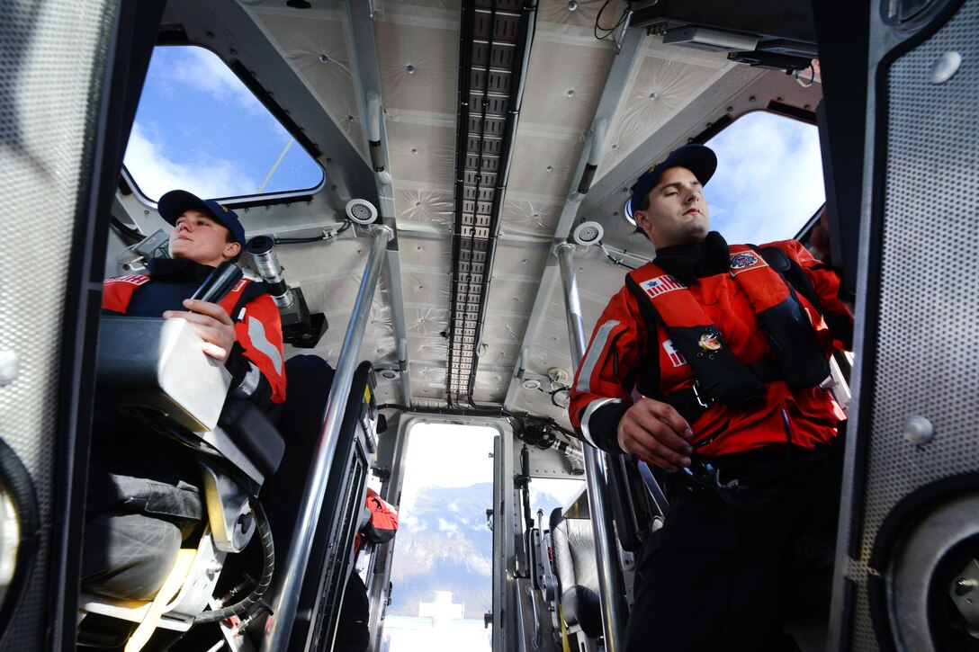 Coast Guard Petty Officer 2nd Class Hali Lombardi, left, pilots the 45-foot response boat during a man overboard drill in Valdez Harbor on Prince William Sound, Alaska, Sept. 13, 2016. Lombardi is assigned to Coast Guard Station Valdez, and completed a check ride for coxswain qualification. Coast Guard photo by Petty Officer 1st Class Bill Colclough