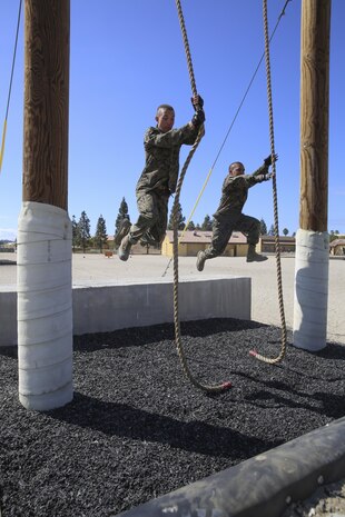 Recruits from Hotel Company, 2nd Recruit Training Battalion, swing from one platform to another during Confidence Course II at Marine Corps Recruit Depot San Diego, Sept. 13. The course allows recruits to build self-confidence and feel accomplished when completing an obstacle.  Annually, more than 17,000 males recruited from the Western Recruiting Region are trained at MCRD San Diego. Hotel Company is scheduled to graduate Nov. 9.