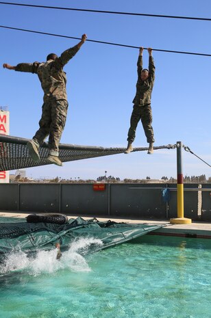 A recruit from Hotel Company, 2nd Recruit Training Battalion, falls into water after failing to complete a change of grip on an obstacle called the Slide for Life during Confidence Course II at Marine Corps Recruit Depot San Diego, Sept. 13. Halfway through the obstacle, recruits are instructed to change positions while hanging above the pool. Annually, more than 17,000 males recruited from the Western Recruiting Region are trained at MCRD San Diego. Hotel Company is scheduled to graduate Nov. 9.
