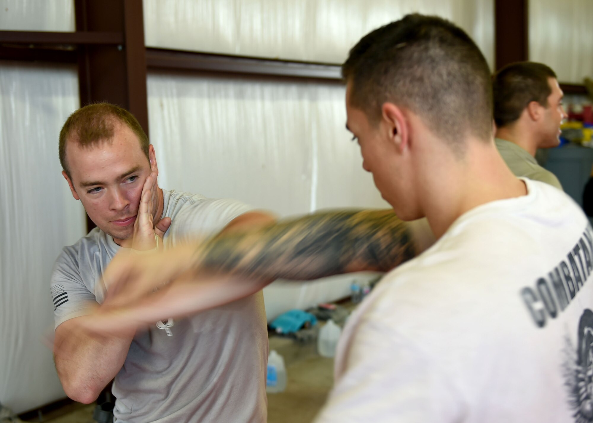 U.S. Air Force Staff Sgt. Adam Robinson, 97th Security Forces Squadron military working dog handler, blocks a punch from U.S. Air Force Senior Airman Christian Calvillo, 97 SFS combat arms instructor, on Sept. 13, 2016, Altus Air Force Base, Okla. 97th SFS Airmen participated in a week-long training course that taught hand-to-hand defensive and subduing techniques, weapons handling and clearing and securing buildings, aircraft and buses as a team. (U.S. Air Force photo by Airman 1st Class Kirby Turbak/Released)   