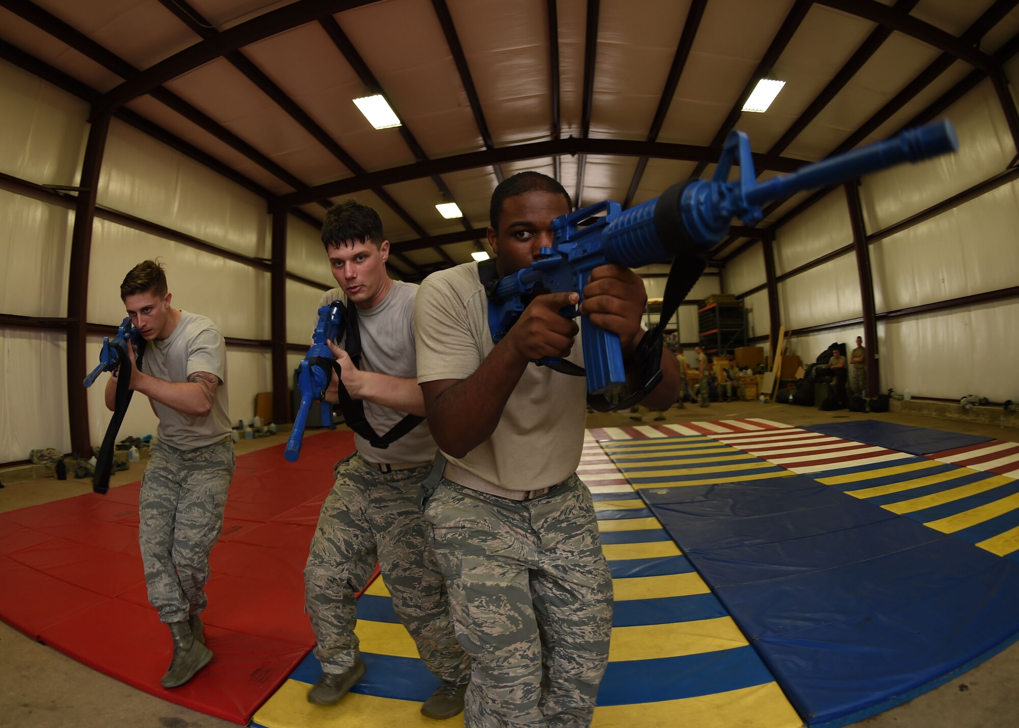 Members of the 97th Security Forces Squadron practice tactical movements on Sept. 13, 2016, Altus Air Force Base, Okla. 97th SFS Airmen participated in a week-long training course that taught hand-to-hand defensive and subduing techniques, weapons handling and clearing and securing buildings, aircraft and buses as a team. (U.S. Air Force photo by Airman 1st Class Kirby Turbak/Released)   