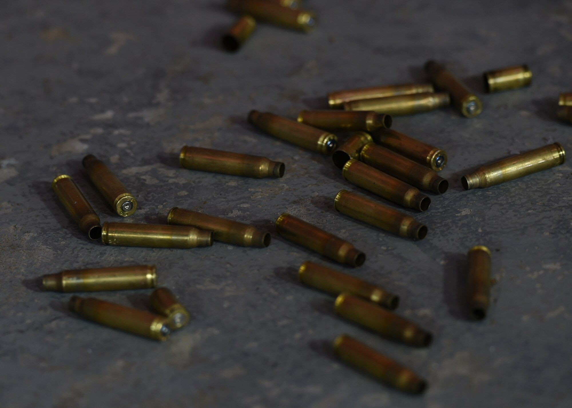 Bullet casings lie on the ground during live fire training on Sept. 14, 2016, Altus Air Force Base Okla. 97th SFS Airmen participated in a week-long training course that taught hand-to-hand defensive and subduing techniques, weapons handling and clearing and securing buildings, aircraft and buses as a team. (U.S. Air Force photo by Airman 1st Class Kirby Turbak/Released)   