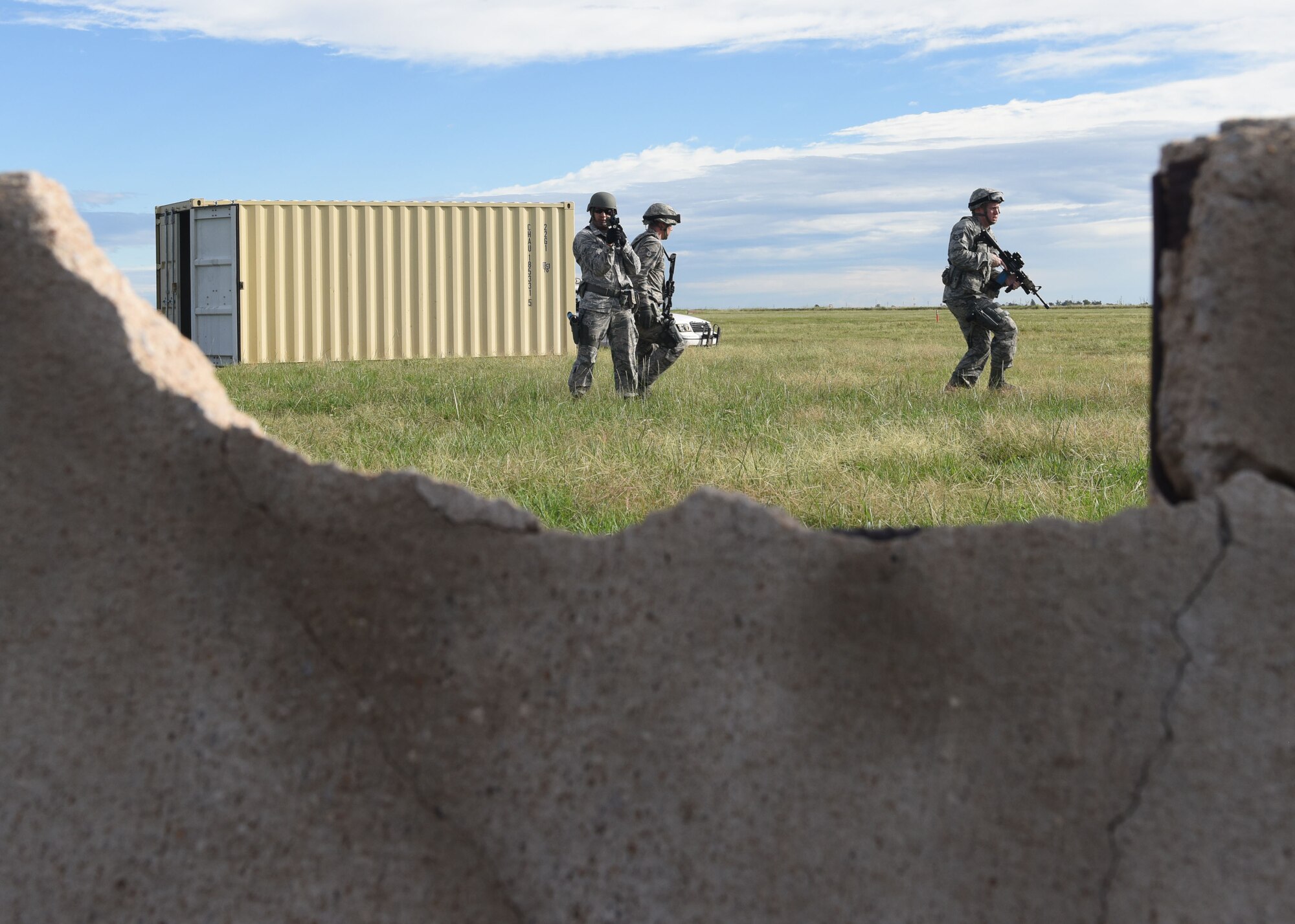 97th Security Forces members clear and secure an area during a training simulation, Sept. 16, 2016. 97th SFS Airmen participated in a week-long training course that taught hand-to-hand defensive and subduing techniques, weapons handling and clearing and securing buildings, aircraft and buses as a team. (U.S. Air Force photo by Senior Airman Nathan Clark/Released)