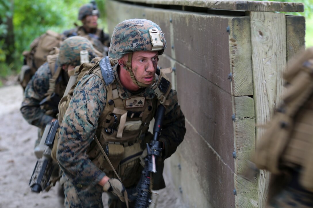 Corporal Christopher Rowe prepares to enter a compound during a training exercise at Camp Lejeune, N.C., Sept. 14, 2016. The Marines participated in a squad rifle competition where they competed in land navigation, shooting and combat skills events. Rowe is a rifleman with 1st Battalion, 8th Marine Regiment. (U.S. Marine photo by Lance Cpl. Jon Sosner)