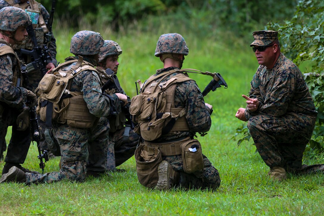 Chief Warrant Officer 4 Thomas Maguire discusses how the Marines performed during a training exercise at Camp Lejeune, N.C., Sept. 14, 2016. The Marines participated in a squad rifle competition where they competed in land navigation, shooting and combat skills events. Maguire is an Infantry Weapons Officer for the 8th Marine Regiment. (U.S. Marine photo by Lance Cpl. Jon Sosner)