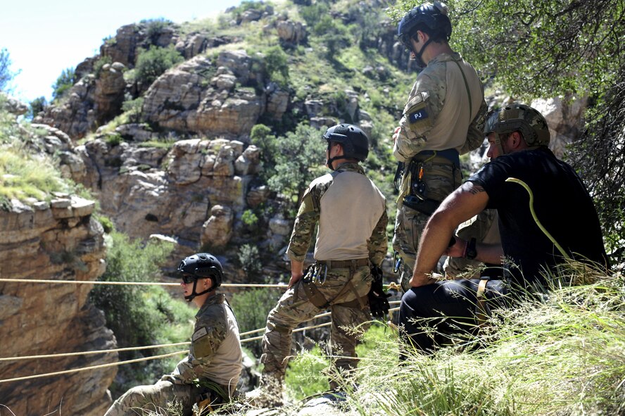 Pararescuemen from the 48th Rescue Squadron stand by for a team member to cross a ravine on a highline at the Coronado National Forest in Tucson, Ariz., Sept. 16, 2016. The 48th RQS deploys Guardian Angel forces worldwide in support of national security objectives and homeland defense. (U.S. Air Force photo by Airman Nathan H. Barbour)