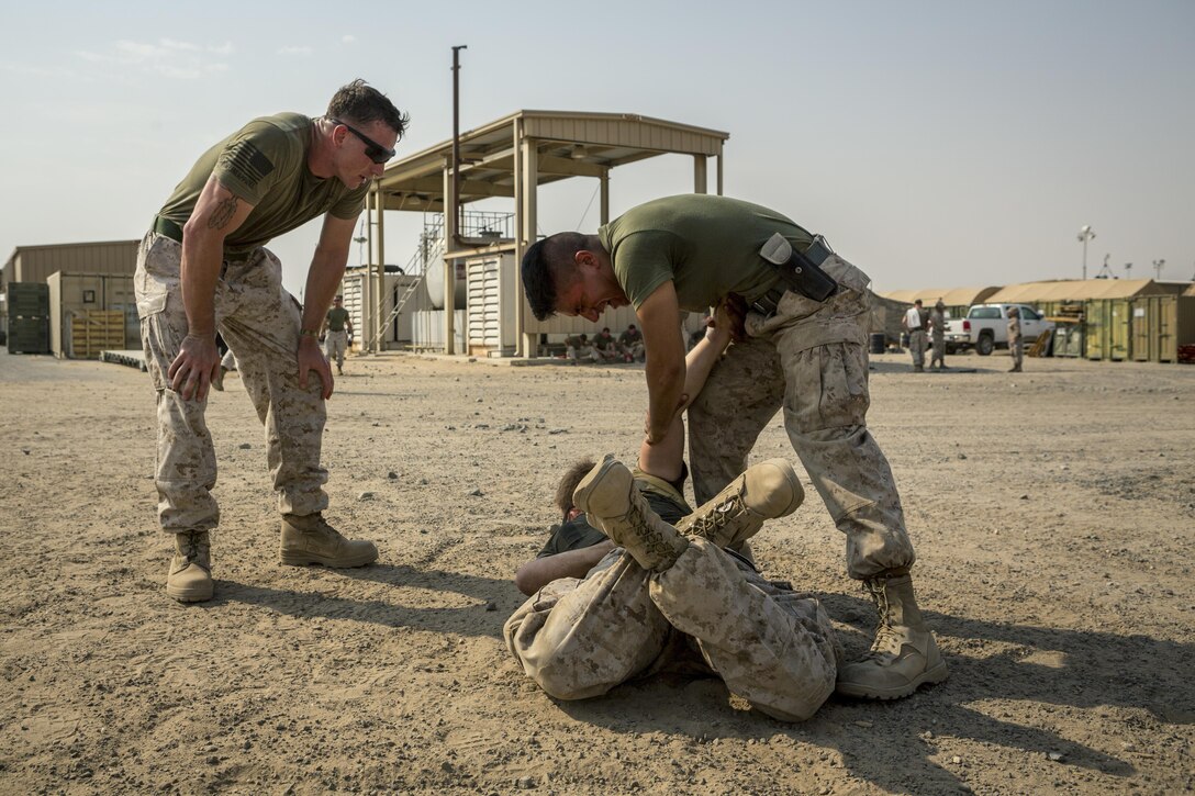 U.S. Marine Corps Cpl. Darin Keesler (left), a military policeman with Law Enforcement Detachment, Special Purpose Marine Air-Ground Task Force - Crisis Response - Central Command 16.2, supervises Marines through an Oleoresin Capsicum qualification course at an undisclosed location in Southwest Asia, Aug. 27, 2016. U.S. Marines and Sailors assigned to Special Purpose Marine Air-Ground Task Force-Crisis Response-Central Command support operations, contingencies and security cooperation in Marine Corps Forces Central Command and U.S. Central Command area of responsibility. (U.S. Marine Corps photo by Sgt. Donald Holbert)