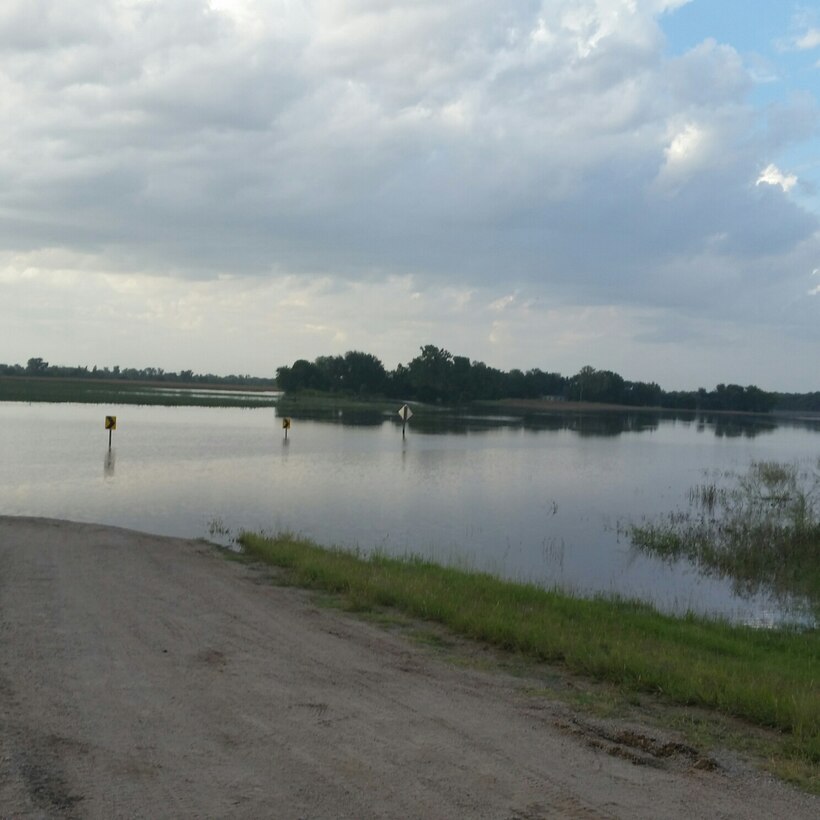 The Ninnescah River spills into Viola, Kan., shortly after heavy rains Sept. 9, 2016. With the flooding in South Central Kansas this month, most people were left grasping for umbrellas, while some unlucky residents had to forge an escape route.  For the family of Master Sgt. Andrew McGhee, 931st Force Support Squadron training manager, the latter was true on the evening of September 9.  (Courtesy photo)