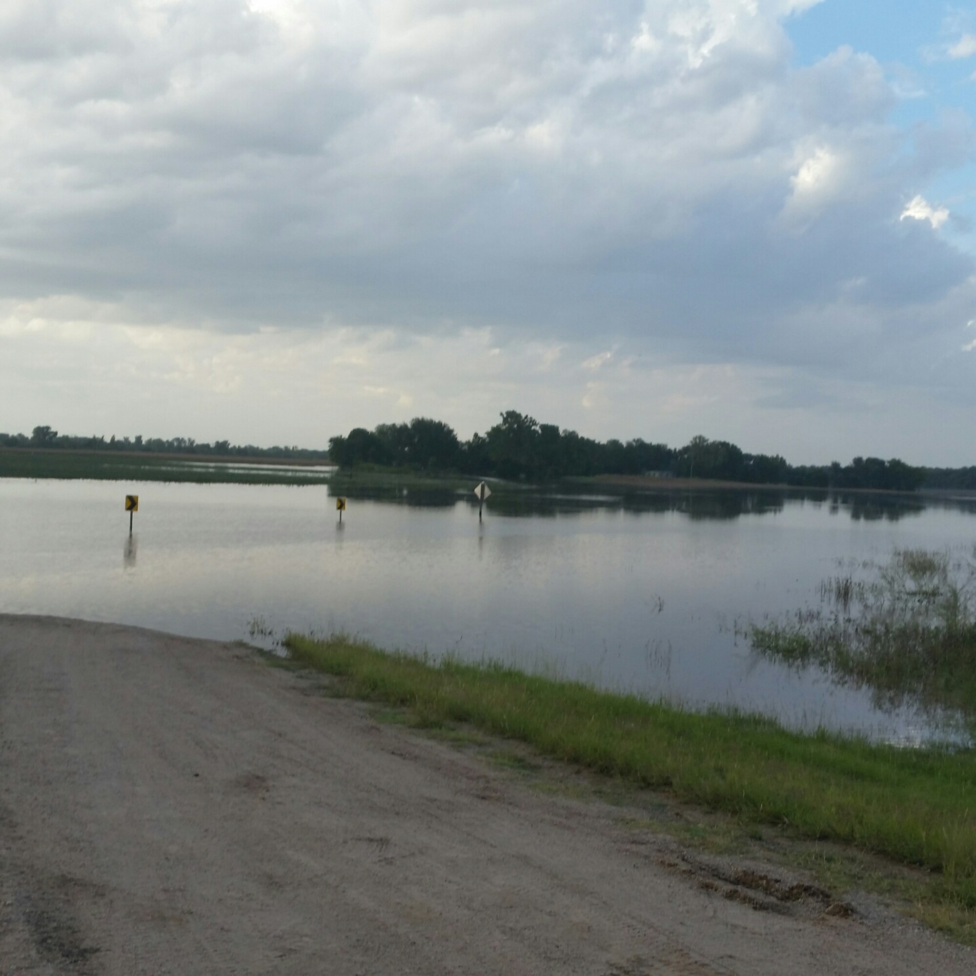 The Ninnescah River spills into Viola, Kan., shortly after heavy rains Sept. 9, 2016. With the flooding in South Central Kansas this month, most people were left grasping for umbrellas, while some unlucky residents had to forge an escape route.  For the family of Master Sgt. Andrew McGhee, 931st Force Support Squadron training manager, the latter was true on the evening of September 9.  (Courtesy photo)