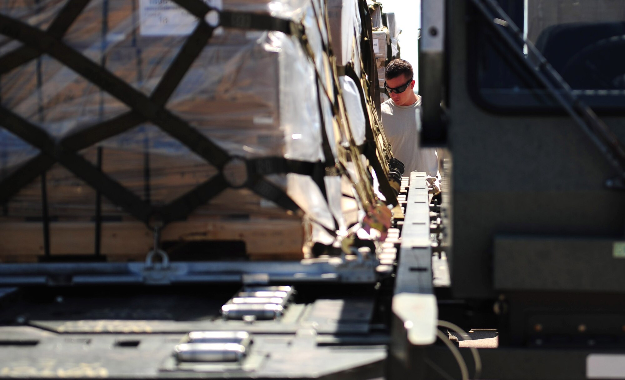 U.S. Air Force Staff Sgt. Eric Hazelwood, 7th Logistics Readiness Squadron air transportation craftsman, prepares to load pallets at Dyess Air Force Base, Texas, Sept. 20, 2016. This cargo was donated from Global Samaritan Resources based in Abilene, Texas, and the food will be transported to an air base near Erbil, Iraq, for distribution to Iraqi refugees. (U.S. Air Force photo by Airman 1st Class April Lancto)