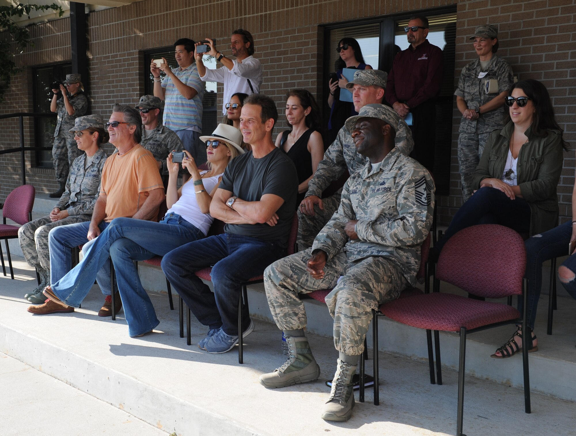 Kurt Russell, Kate Hudson, Deepwater Horizon actors, and Peter Berg, Deepwater Horizon director, watch a 336th Training Squadron drill down demonstration at the Levitow Training Support Facility drill pad before the Deepwater Horizon movie screening Sept. 20, 2016, on Keesler Air Force Base, Miss. Before the screening, Russell, Hudson and Berg, took a short tour of the 81st Training Wing and 403rd Wing to meet with Airmen and learn about their missions at Keesler. (U.S. Air Force photo by Kemberly Groue/Released)