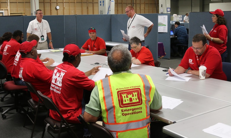 Chris Klein (L), South Atlantic Division, temporary housing program manager and Jon Wilson (R), a haul and install action officer from the U.S. Army Engineering and Support Center, Huntsville, give an in-brief to newly arrived Quality Assurance Representatives.  QARs are deploying from throughout the Army Corps of Engineers in support of the Baton Rouge severe storms and flooding.  The QARs are responsible for Manufactured Home Unit site inspection reports and inspecting the MHUs before they are occupied.