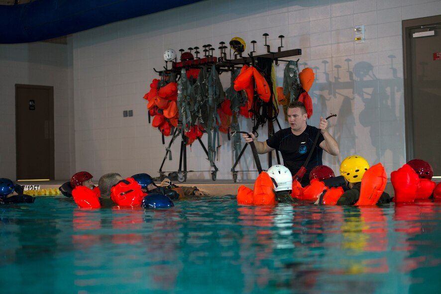 U.S. Air Force Tech. Sgt. Travis Siegwart, 347th Operations Support Squadron NCO in charge of survival, evasion, resistance and escape training, teaches aircrew members hoisting operating procedures during water survival training, Sept. 15, 2016, at Moody Air Force Base, Ga. Siegwart is responsible for helping aircrew members test their survival skills in adverse situations if ejected during aircraft incidents. (U.S. Air Force photo by Airman 1st Class Greg Nash)