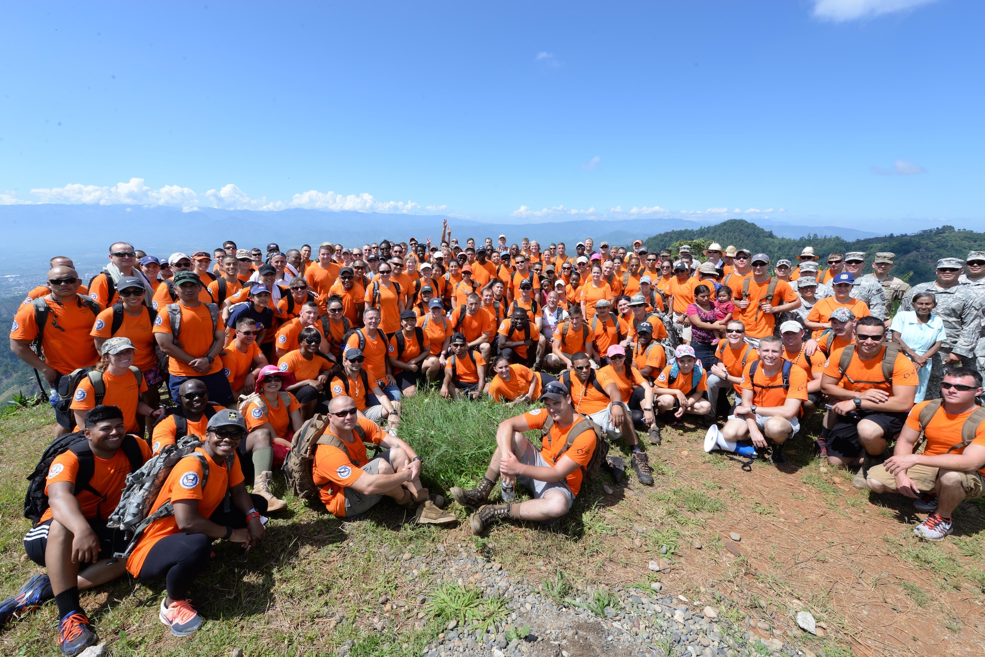 U.S. military members based out of Soto Cano Air Base, Honduras, take a break and pose for a photo, during Chapel Hike 64, Oct. 31, 2015. Chapel Hikes take place every six weeks and provide community outreach by bringing much needed food and supplies to the less fortunate. (U.S. Air Force photo by Senior Airman Westin Warburton)