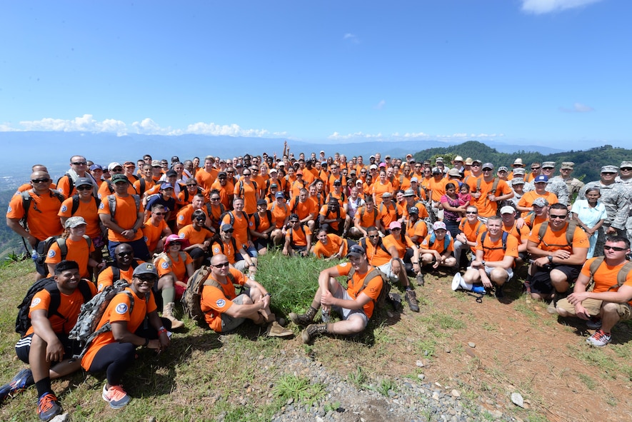 U.S. military members based out of Soto Cano Air Base, Honduras, take a break and pose for a photo, during Chapel Hike 64, Oct. 31, 2015. Chapel Hikes take place every six weeks and provide community outreach by bringing much needed food and supplies to the less fortunate. (U.S. Air Force photo by Senior Airman Westin Warburton)