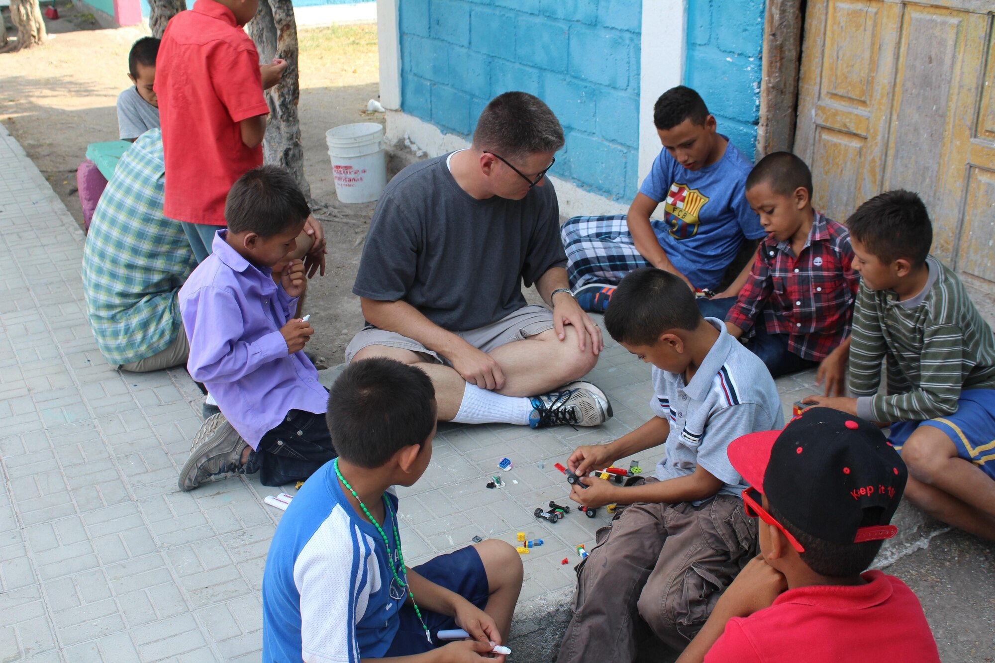 U.S. Air Force Capt. Timothy Dahl, 23d Wing chaplain, visits with boys from an orphanage, in the country of Honduras. Dahl recently deployed to Soto Cano Air Base, Honduras, which is a non-combat zone. This allowed him to venture outside the wire and find volunteer opportunities in the local area, which included community outreach at nine orphanages. (Courtesy photo)