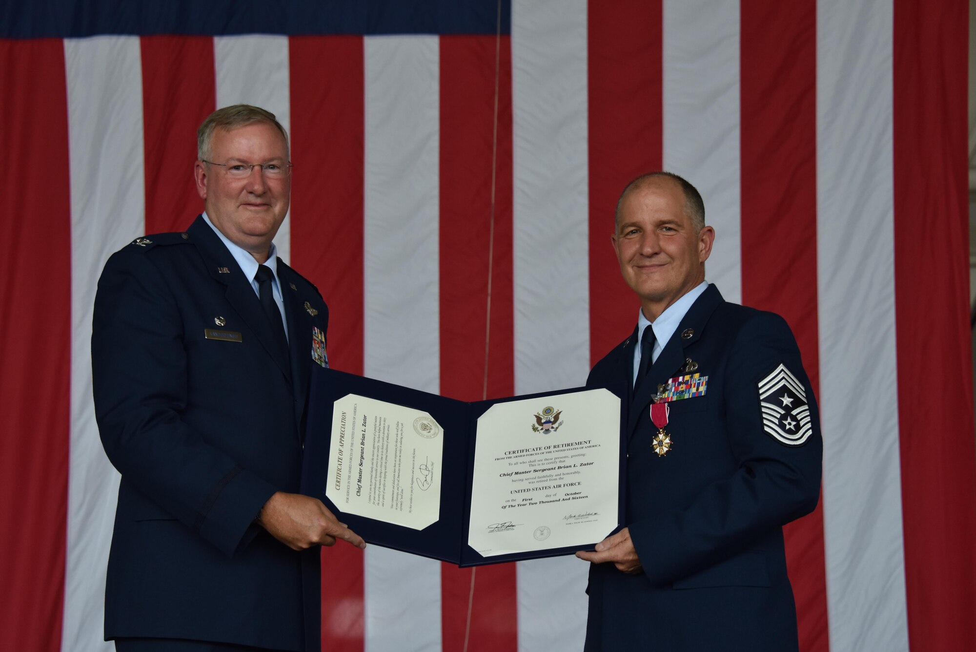 911th Airlift Wing Command Chief Master Sgt. Brian Zator accepts his certificate of retirement during a retirement ceremony at the Pittsburgh International Airport Air Reserve Station, September 10, 2016. Zator retires effective October 1, 2016 after exactly 33 years and 8 days of service. (U.S. Air Force Photo by Staff Sgt. Marjorie A. Bowlden)
