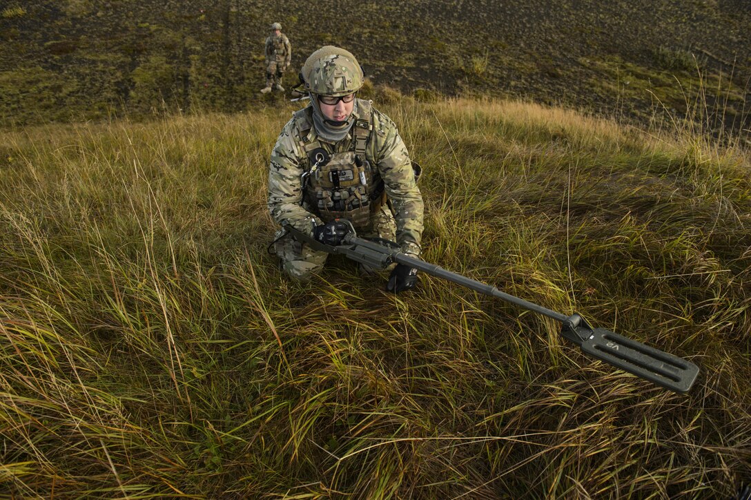 Tech. Sgt. Jason Umlauf, a 52nd Civil Engineer Squadron explosive ordnance disposal craftsman, sweeps an area with a mine detector during exercise Northern Challenge 16 in Keflavik, Iceland, Sept. 19, 2016. The exercise focused on disabling improvised explosive devices in support of counterterrorism tactics to prepare Partnership for Peace, NATO, and Nordic nations for international deployments and defense against terrorism. (U.S. Air Force photo/Staff Sgt. Jonathan Snyder)