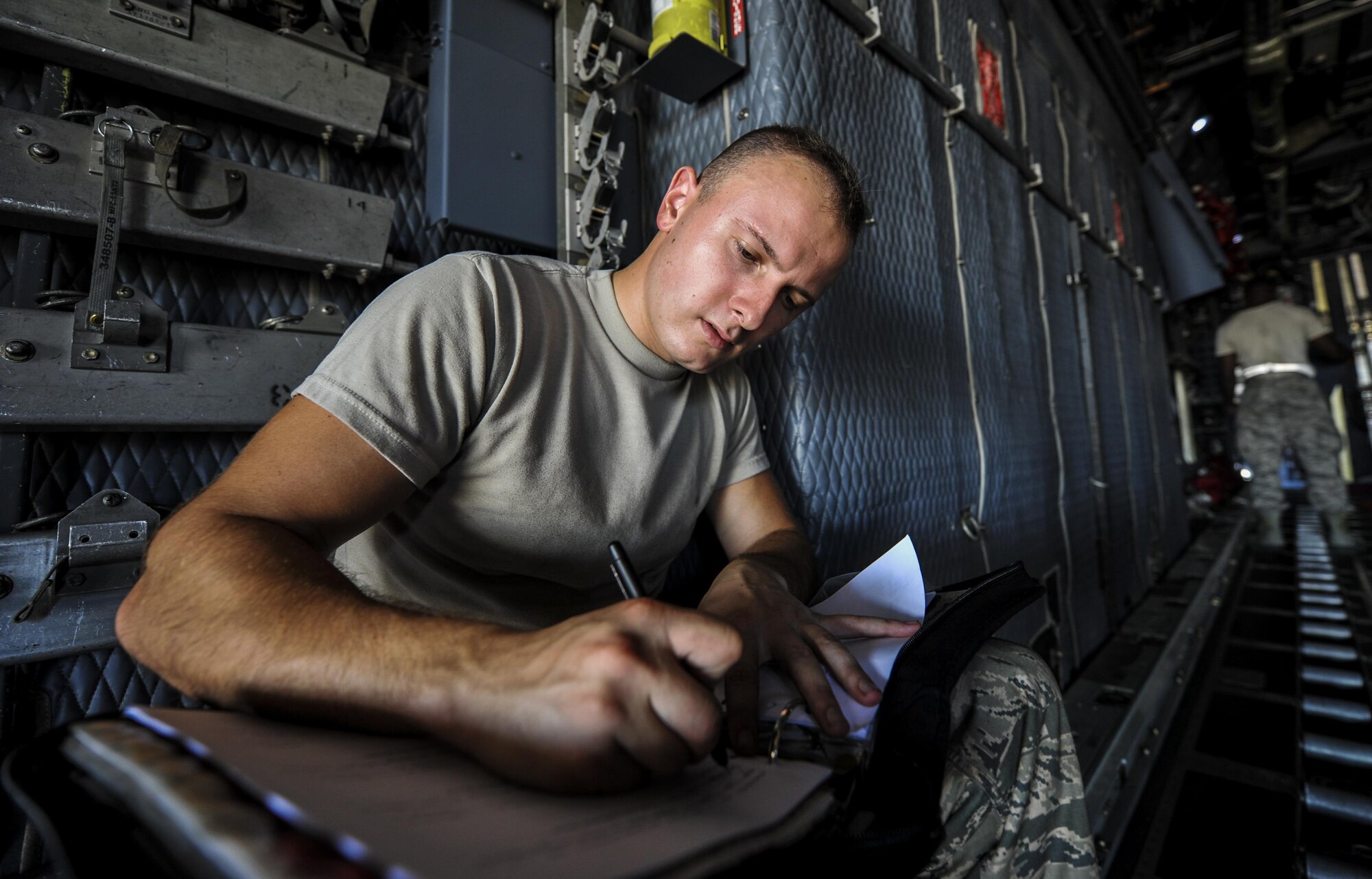 Airman 1st Class Nicolas Stamper, a crew chief with the 15th Aircraft Maintenance Unit, fills out forms onboard an MC-130H Combat Talon II at Hurlburt Field, Sept. 21, 2016. Crew chiefs with the 15th AMU are trained to diagnose malfunctions on the MC-130H Combat Talon II during pre-flight and post-flight inspections, repair and refuel the aircraft, keep detailed records, marshal aircraft and ensure the aircraft are mission ready at all times. (U.S. Air Force photo by Airman 1st Class Joseph Pick)