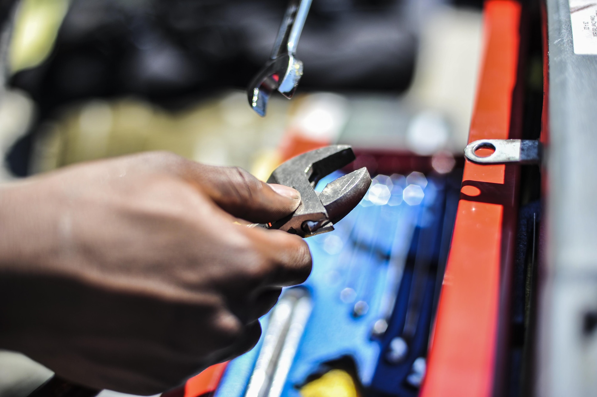 Airman 1st Class Lewis Morant, a crew chief with the 15th Aircraft Maintenance Unit, holds an adjustable wrench at Hurlburt Field, Fla., Sept. 21, 2016. Crew chiefs with the 15th AMU are trained to diagnose malfunctions on the MC-130H Combat Talon II during pre-flight and post-flight inspections, repair and refuel the aircraft, keep detailed records, marshal aircraft and ensure the aircraft are mission ready at all times. (U.S. Air Force photo by Airman 1st Class Joseph Pick)