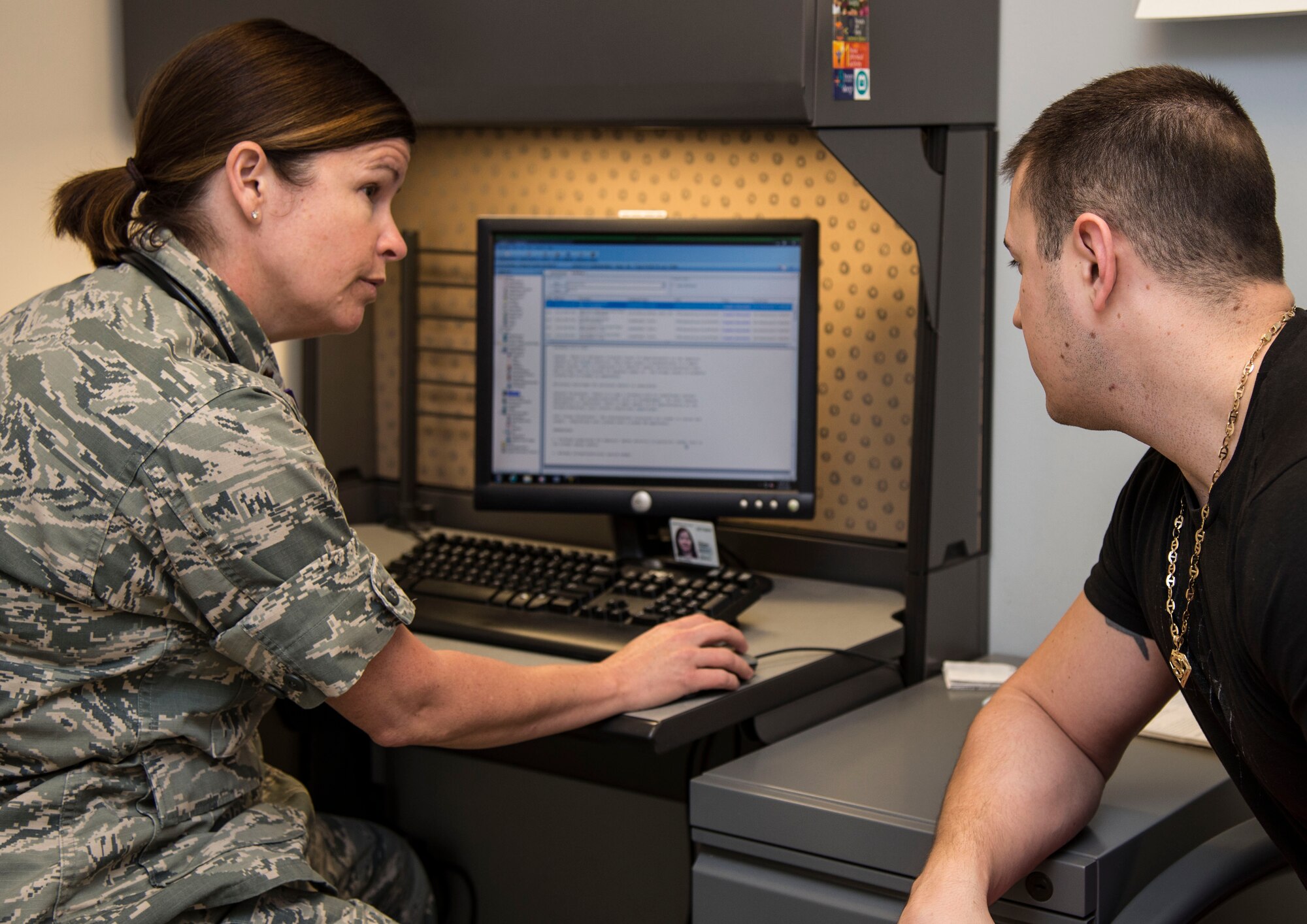 Maj. Tiffany Williams, Uniformed Services University of the Health Sciences doctoral student, speaks with a patient Aug.19, 2016, at Scott Air Force Base, Ill. In July of this year, for the first time ever, the 375th Medical Group became a training site for Family Nurse Practitioner students enrolled in USUHS. (U.S. Air Force phot by Airman 1st Class Melissa Estevez)