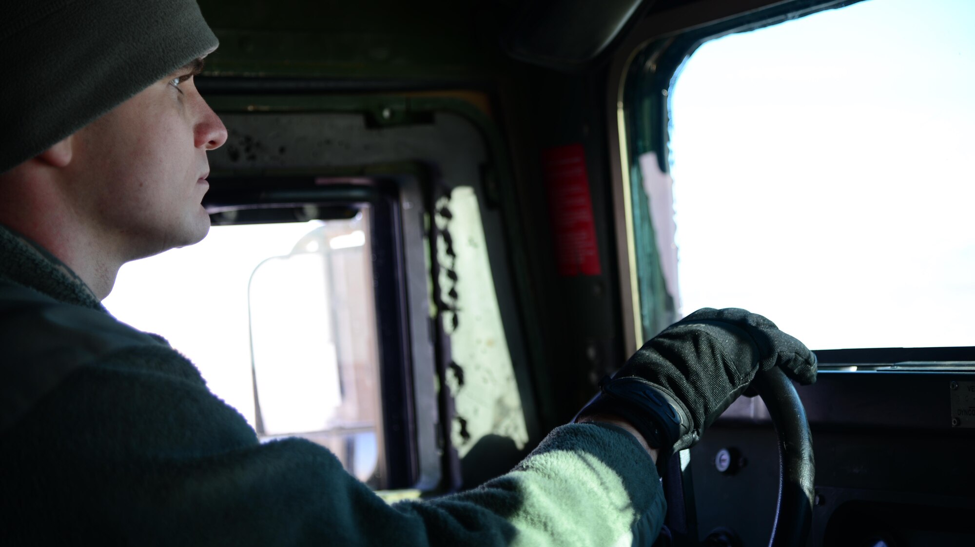 Senior Airman Brian Darnell, 341st Missile Security Forces Squadron trainer, drives a Humvee Jan. 19, 2016, at Malmstrom Air Force Base, Mont. Beginning Oct. 1, Airmen deploying to the missile field are required to have a cold weather gear bag accessible at all times including gloves and fleece caps. (U.S. Air Force photo/Airman 1st Class Magen M. Reeves)