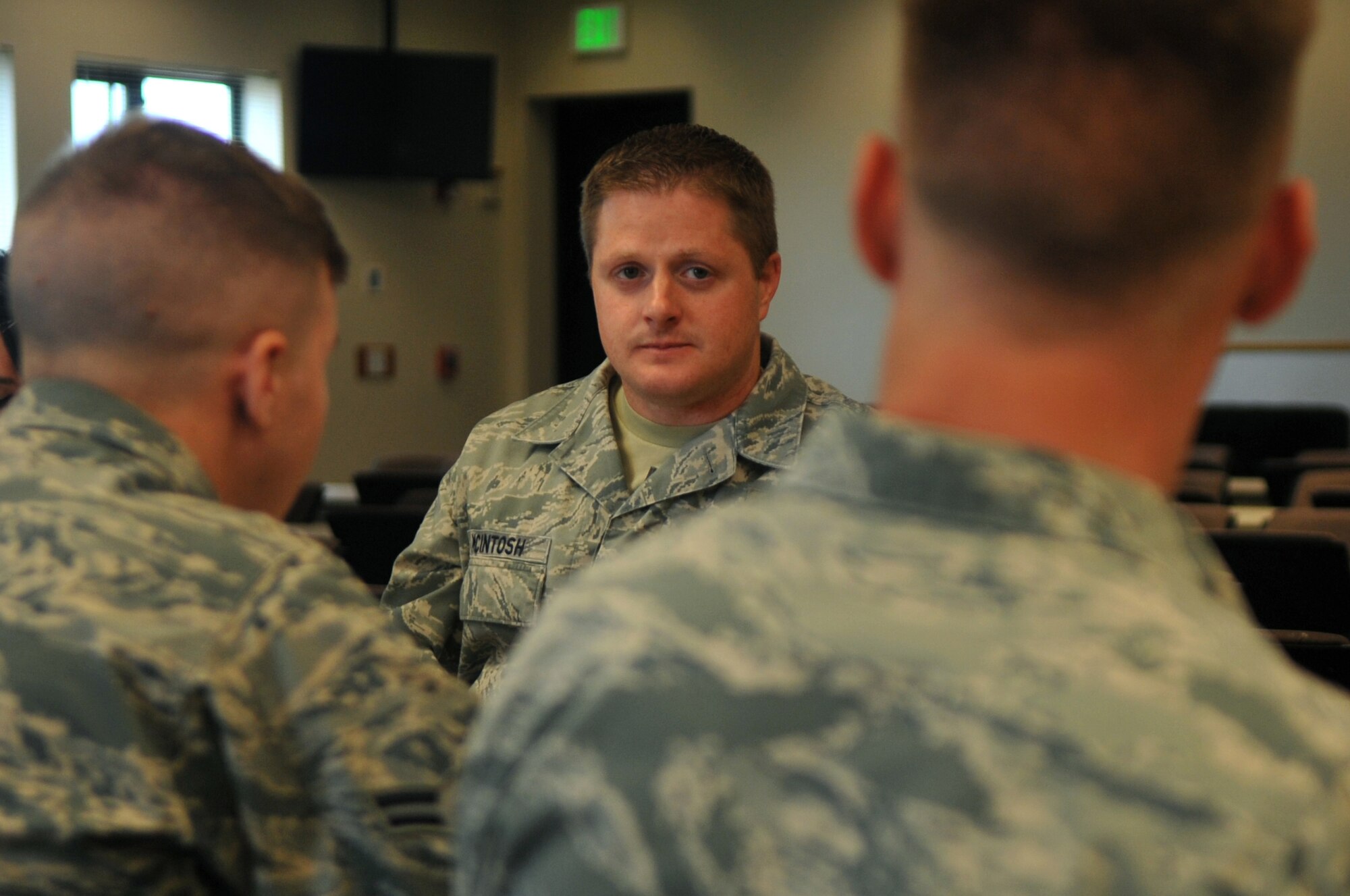 Tech. Sgt. John McIntosh, Buckley Air Force Base Chapel operations NCO in charge, sits with new Airmen during lunch September 15, 2016, at Buckley AFB, Colo. The role of a chaplain assistant is to provide ministry support through direct unit involvement and administrative and logistical support. (U.S. Air Force photo by Airman Holden S. Faul/ Released) 
