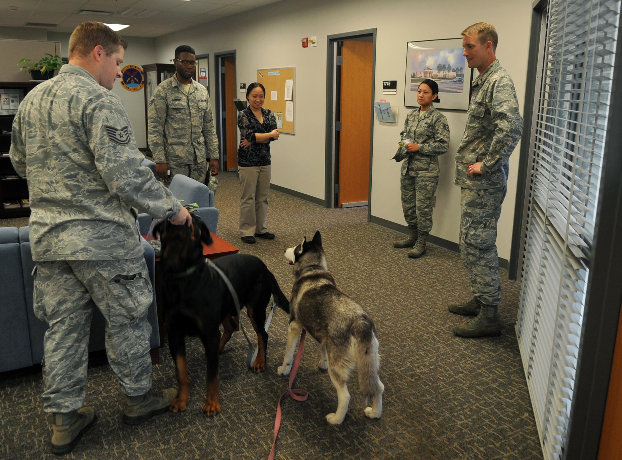 Tech. Sgt. John McIntosh, Buckley Air Force Base Chapel operations NCO in charge, takes his dogs to visit with Team Buckley as an opportunity to raise morale September 15, 2016, at Buckley AFB, Colo. Chaplain assistants are crucial to keeping the morale of Airmen high to insure they’re spiritually fit to perform their jobs. (U.S. Air Force photo by Airman Holden S. Faul/ Released) 