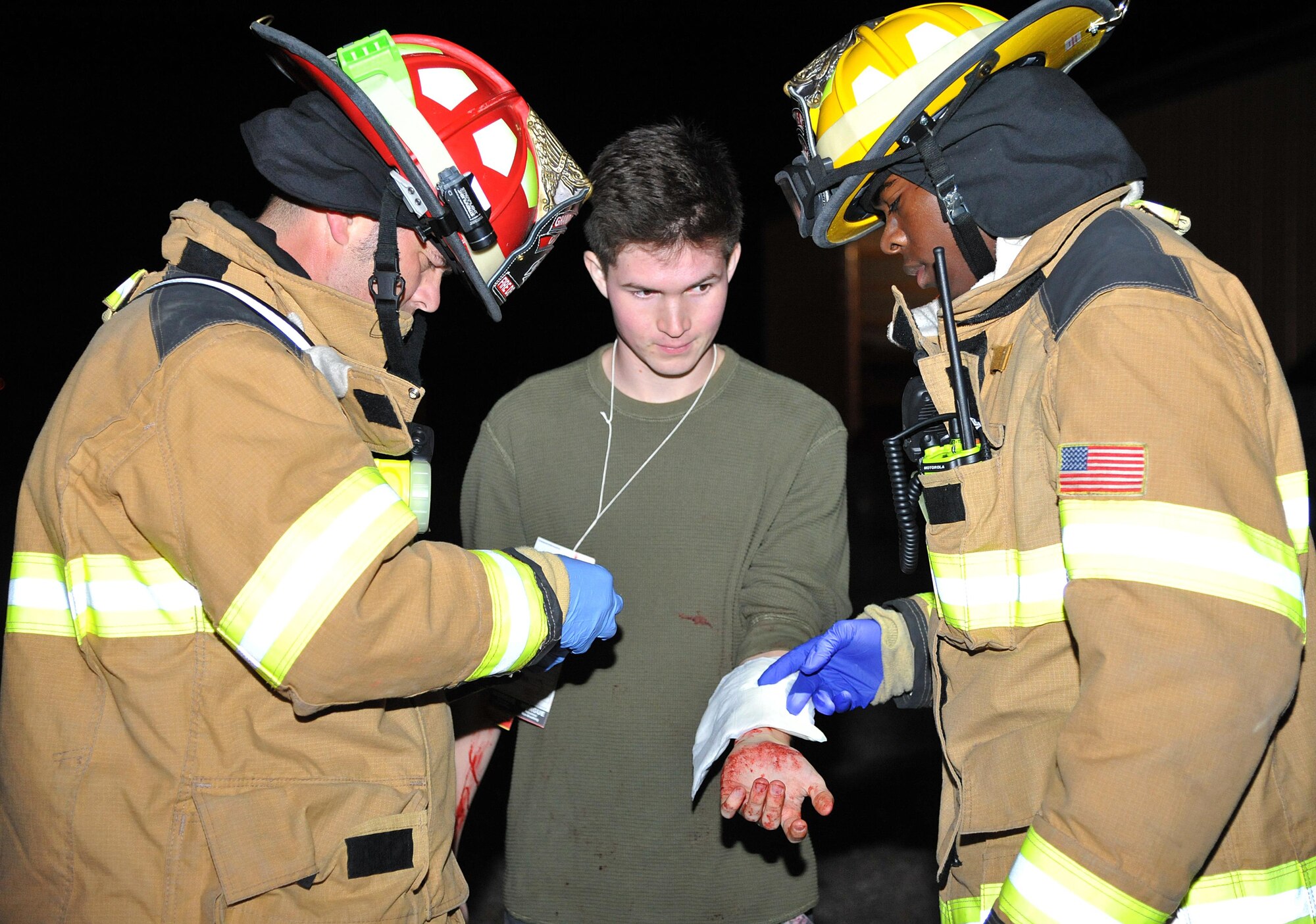 Grand Forks AFB firefighters practice first aid procedures on a simulated plane crash victim during an exercise at the Grand Forks International Airport, N.D., Sept. 21, 2016. Grand Forks AFB firefighters joined area fire depts. and other first responders for a community effort to develop readiness for emergency response. (U.S. Air Force photo by Airman 1st Class Elijaih Tiggs)