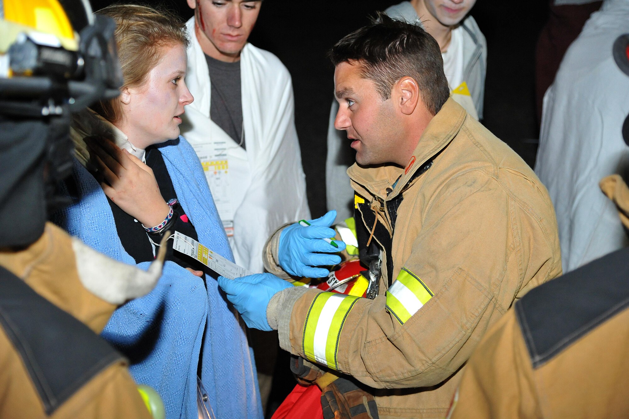 Grand Forks area firefighters practice assisting volunteer victims of a simulated plane crash during an exercise at the Grand Forks International Airport, N.D., Sept. 21, 2016. Grand Forks AFB firefighters joined area fire depts. and other first responders for a community effort to develop readiness for emergency response. (U.S. Air Force photo by Airman 1st Class Elijaih Tiggs)