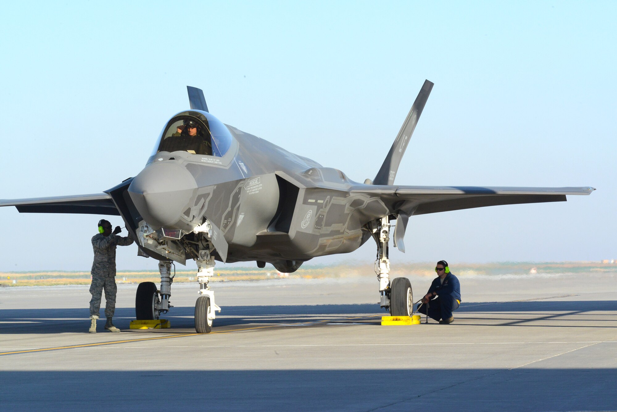 Airman 1st Class Nkosi Jones, left, 61st Aircraft Maintenance Unit weapons Airman, secures a panel while Staff Sgt. Martin De La Vara, 61st AMU crew chief, prepares to pull the chocks September 16, 2016, prior to launching an F-35 Lightning II at Mountain Home Air Force Base, Idaho. Luke sent jets to Mountain Home AFB because it provides a unique opportunity for developing proficiency in the destruction of surface-to-air threats at their range complex. (U.S. Air Force photo by Tech. Sgt. Timothy Boyer)